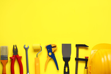 Set of construction tools on yellow background
