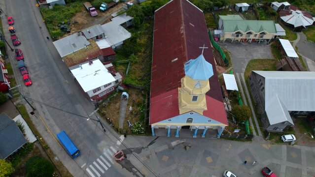 Aerial Drone Fly Top Down Patrimonial Church Chonchi in Chilo&eacute; Chile South American religious Building at Patagonia, Streets and Car Traffic