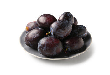 Plate with ripe plums on white background