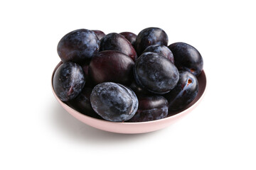 Bowl with ripe plums on white background