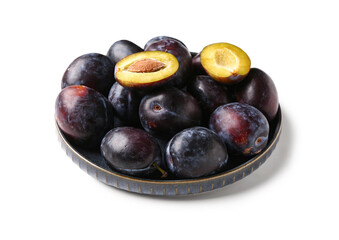 Plate with ripe plums on white background