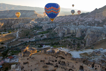 Breathtaking hot air balloon flight at dawn over unique rocky landscapes, perfect for adventure...