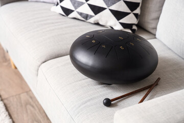 Glucophone with sticks on sofa in living room, closeup