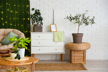 Interior of living room with green plants, drawers and glowing lights