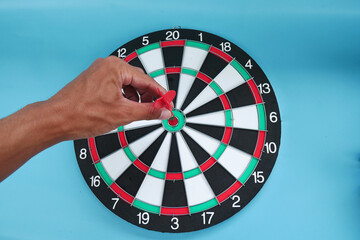 The human hand and arrow hit the center of the target board