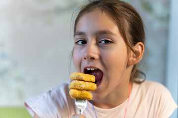 Fast food. Young girl eating crispy fried chicken.