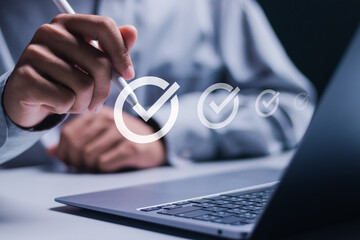 Checklist concept. Businessman using laptop to checking mark on checkboxes on digital screen.