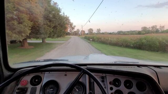 Driving old truck on gravel road of rural America, POV view