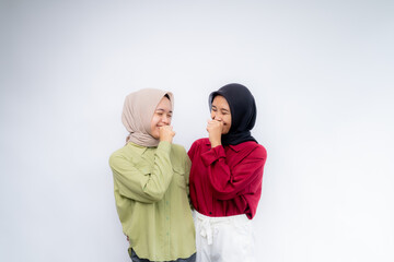 Be happy. Portrait of young two asian woman wearing hijab at Copy Space Advertising Your Text, Standing Isolated Over white Studio Background