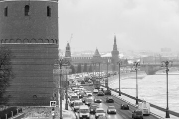 View of the Kremlin embankment from the Bolshoy Kamenny Bridge during a snowfall. Black and white.