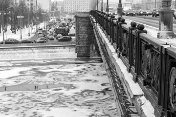 Ice drift on the winter Moscow River under the Bolshoi Kamenny bridge on the Kremlin embankment....