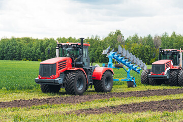harvest field with red tractor mods dry grass. field after harvest. Harvesting in the fields. Stock up on hay for winter. plowing a field with a red tractor. tillage