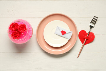 Beautiful table setting for Valentine's Day with decor on white wooden background