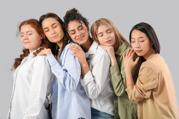 Beautiful young happy women on grey background. Women history month