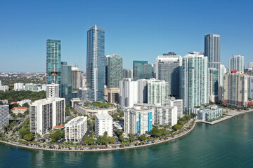 Fototapeta na wymiar Aerial image of waterfront residential buildings in Brickell neighborhood of Miami, Florida reflected in calm water of Biscayne Bay on sunny morning.