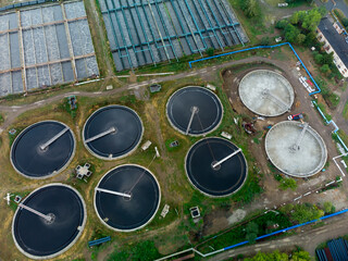 Aerial view of modern water cleaning facility at urban wastewater treatment plant. Purification process of removing undesirable chemicals, suspended solids and gases from contaminated liquid. Tyumen