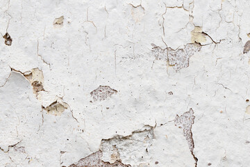 White paint peeling of the surface of a plaster wall, grunge background or texture - 746232781