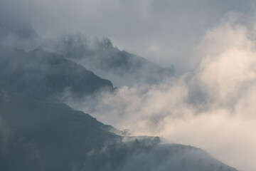 Mountain peaks in the clouds, foggy morning	