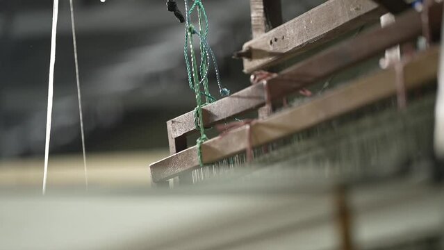 close-up view of a spinning tool on a traditional loom