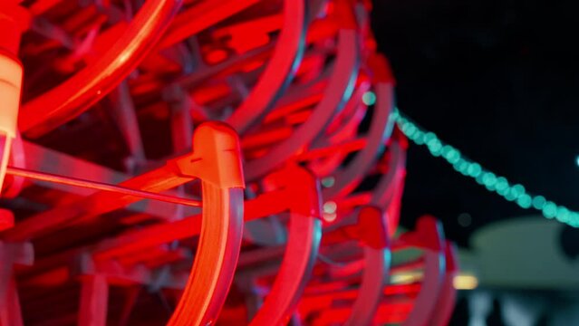 Close up of Sleds illuminated with Red lights creating Art Christmas Tree. Christmas Market University Campus (Altes AKH) in Vienna, Austria. Shot with Sony FX3 in 4K.