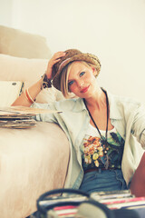 Woman, hat and record with portrait, retro and living room floor for relaxation. Person, couch and...