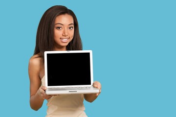 Young happy woman holding laptop computer