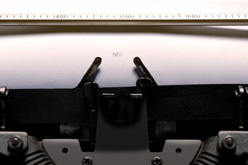 Text of 'new' typed on a vintage typewriter