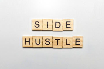 Wooden cube with text side hustle isolated over white background. Side hustle concept.