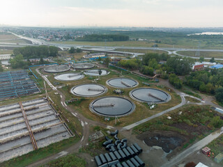 Aerial view of modern water cleaning facility at urban wastewater treatment plant. Purification process of removing undesirable chemicals, suspended solids and gases from contaminated liquid. Tyumen
