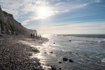 This photograph captures the essence of a peaceful evening beside the sea, where the sun's descent...