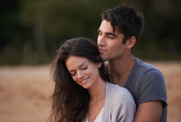 Couple, relax and embrace outdoor with love in nature on holiday or vacation in summer. People, smile and calm moment together on date or travel in Florida to beach and hug partner with gratitude