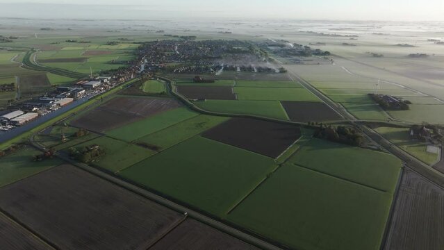 Aerial view of farmland and fields during a foggy morning, Workum, Netherlands