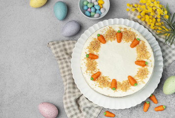 Homemade Easter carrot cake made with walnuts, iced with cream cheese. Sweet dessert.