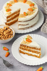 Homemade carrot cake made with walnuts, iced with cream cheese. Sweet dessert.