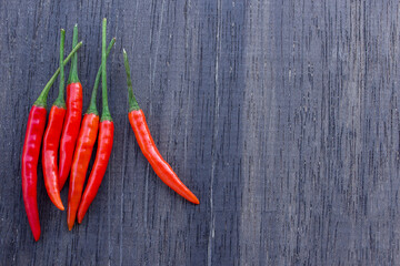 Red chili on an old wooden background.