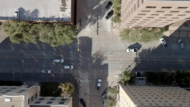 Traffic intersection with cars moving in Abilene, Texas and drone video overhead looking down.
