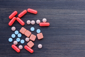 Close up pills on a wooden table.