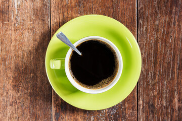Coffee cup on wooden table background