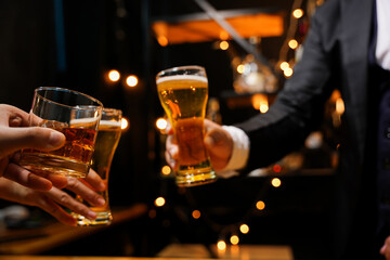food and drink male friends are happy drinking beer and clinking glasses at a bar or pub.