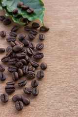 Close up coffee beans and fresh green leaf