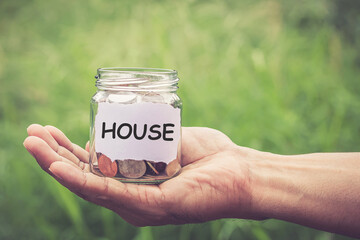 Hands holding money in the jar