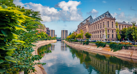 Wonderful morning cityscape of Bucharest city - capital of Romania, Europe. Spectacular summer view of Court of Appeal Building on tne Dambovita river. Traveling concept background. - obrazy, fototapety, plakaty