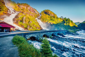 Gorgeous sunny view of Latefoss waterfall, located in the municipality of Odda in Hordaland County. Stone bridge and blue river in Norway, Europe. Beauty of nature concept background.