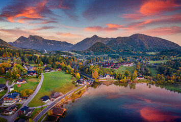 Spectacular autumn view from flying drone of Archkogl village. Marvelous sunrise on Grundlsee lake...
