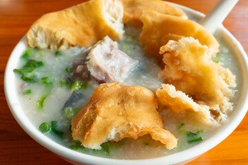 angle view fish porridge with deep-fried Chinese donuts at horizontal composition