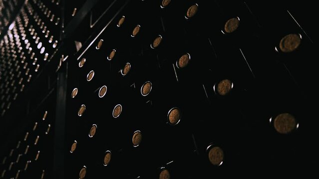Endless rows of aged wine bottles in atmospheric cellar.