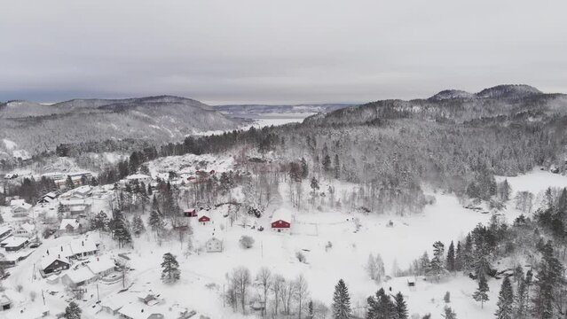 White Snow On House Roofs In Winter. Near Kragero In Telemark, Norway. aerial descending shot