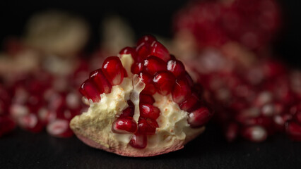Red pomegranate fruit on pastel pink background. Minimal flat lay concept.