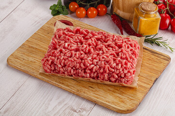Raw minced beef meat over board
