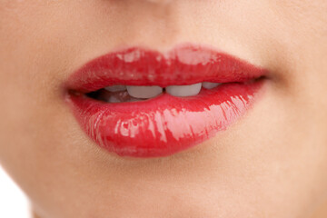 Person, red lipstick and closeup of mouth with makeup for cosmetics, gloss or glow in treatment. Colorful lips of woman or model with bite in satisfaction for mouth, oral or beauty in cosmetology